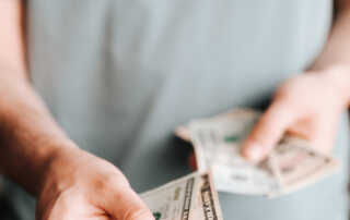 Free Crop man paying with American dollars Stock Photo